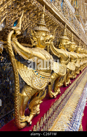 Riga di oro Garudas sul muro esterno di Wat Phra Kaew, o il Tempio del Buddha di smeraldo al Grand Palace complesso in Bangko Foto Stock