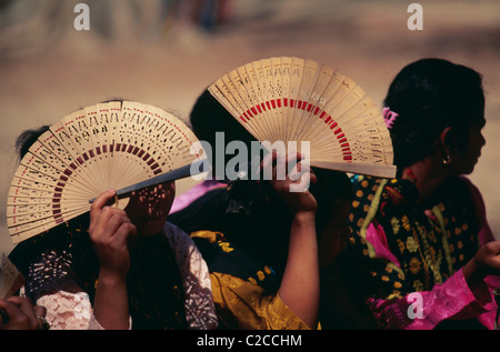 Le donne locali che usano i ventilatori per proteggere contro il sole, villaggio di Riung, Flores, Nusa Tenggara, Indonesia, Asia Foto Stock