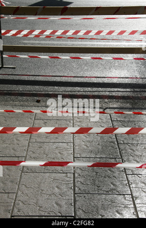 Bianco su rosso nastro temporanea ombra di barriera sulla strada Foto Stock