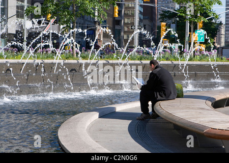 L'uomo da rilassanti fontane in Columbus Circle New York Foto Stock