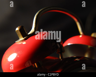 Le campane di un vecchio orologio sveglia in colore rosso e nero parte inferiore Foto Stock