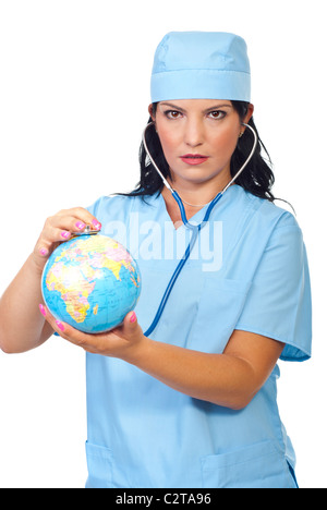 Grave medico donna esaminare Globo mondo con il suo stetoscopio isolati su sfondo bianco Foto Stock