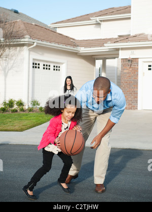 Padre e figlia giocare a basket in strada Foto Stock
