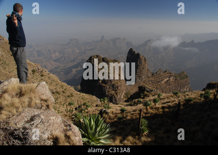 Simien Mountains, l'Etiopia settentrionale: un trekker sta davanti al buttes e mesas visto dal punto di vista dei Imet Gogo. Foto Stock