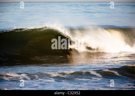 Un surfista ottiene canna presso la Santa Clara foce in Ventura, California. Foto Stock