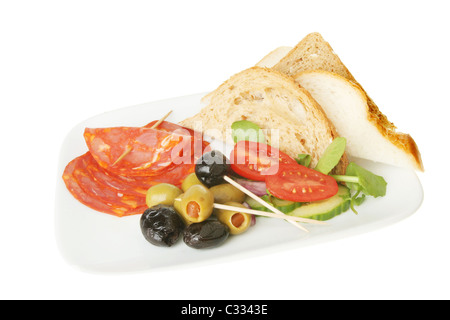 Le tapas del chorizo olive insalata e pane su una piastra isolata contro bianco Foto Stock