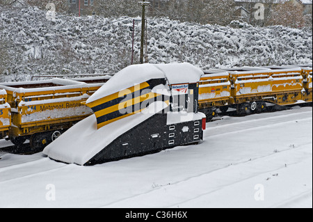 Stazione ferroviaria spartineve e camion visto nella caduta di neve a Tonbridge West Yard Kent, Regno Unito Foto Stock