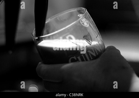 Una pinta di Guinness che viene tirata in Sissy McGintys Pub, Castlerea, nella contea di Roscommon, Irlanda. Foto Stock