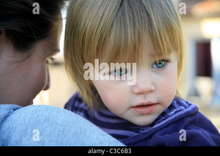 Il Toddler essendo portati dalla mamma Foto Stock