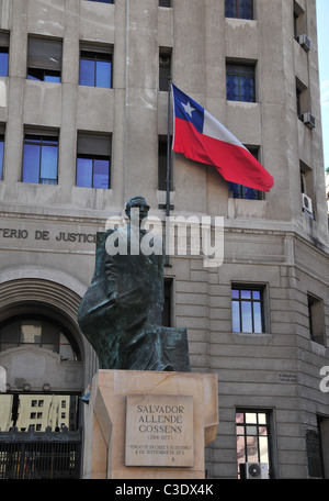 Statua in bronzo del Presidente Salvador Allende su uno zoccolo in pietra nella parte anteriore di un ministero di giustizia bandiera cilena, Santiago del Cile Foto Stock