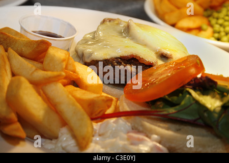 Formaggio e bacon burger sulla piastra in attesa di essere servito al cliente Foto Stock