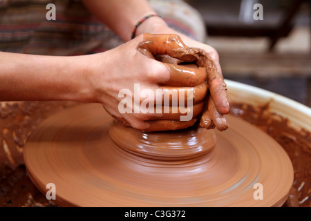 Creta mani potter closeup lavorando sulla ruota artigianato lavori di ceramica Foto Stock