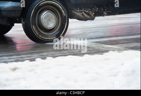 Close up di auto di ruote su strada in inverno Foto Stock