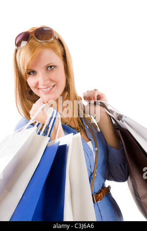 Shopping giovane donna con borsa su bianco Foto Stock