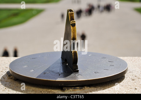 Primo piano di un antico orologio solare in rame nella parte anteriore di un giardino Foto Stock