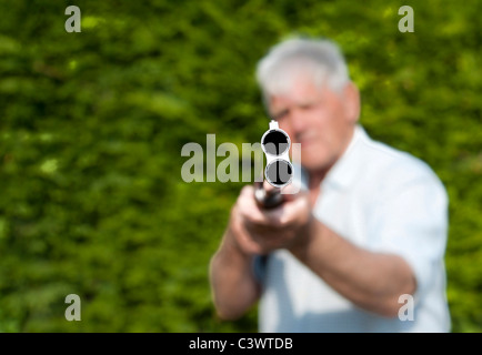 Un uomo indica doppia canna fucile a telecamera.formato paesaggio.copia dello spazio. Foto Stock