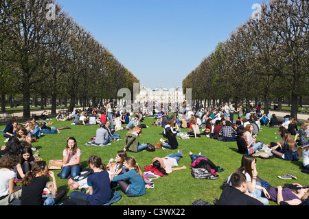 Gli studenti aventi il pranzo sul prato di fronte al Palais du Luxembourg a inizio primavera sole, Jardin du Luxembourg, Parigi, Francia Foto Stock