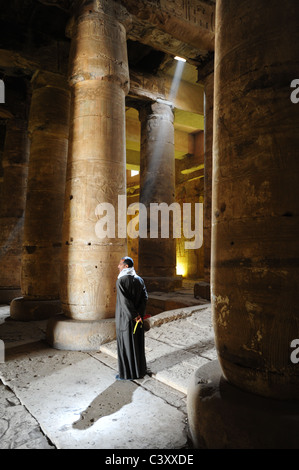 Africa Medio Oriente Egitto Antico egiziano - Dendara Casa di Hathor - uomo in piedi è un albero della luce solare all'interno del tempio Foto Stock