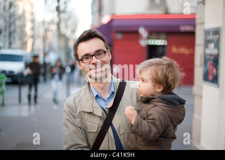 Uomo che porta il toddler figlio, ritratto Foto Stock