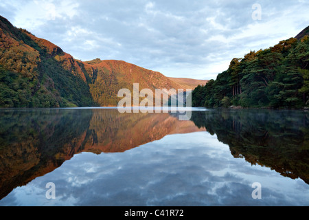 Alba riflessi nel Lago Superiore, Glendalough, il Parco Nazionale di Wicklow Mountains, County Wicklow, Irlanda. Foto Stock