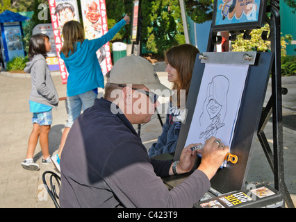 Una caricatura essendo disegnato di una ragazza al SeaWorld. Foto Stock