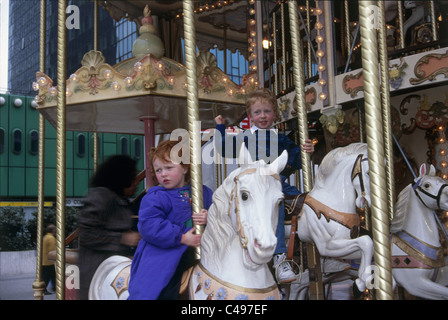 Fotografia di bambini cavalcare cavalli in legno su un merry-go-round a Parigi Foto Stock