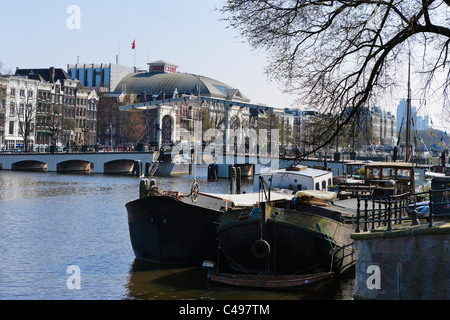 Le chiatte sul fiume Amstel di fronte al ponte Magere, Amsterdam, Paesi Bassi Foto Stock