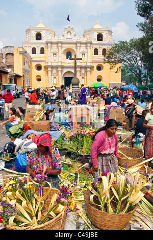 Le donne maya lavorazione artigianale palme di fronte ( Chiesa in Antigua per essere venduti per la Settimana Santa (Semana Santa) Foto Stock