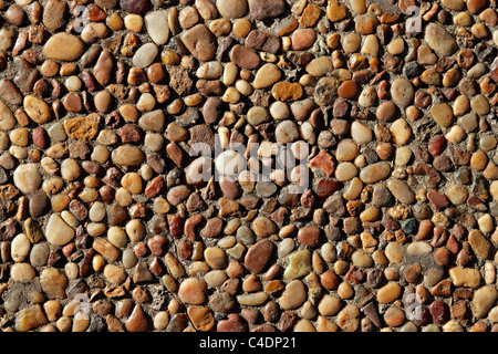 Sullo sfondo di un piccolo lisci ciottoli di pietra Foto Stock