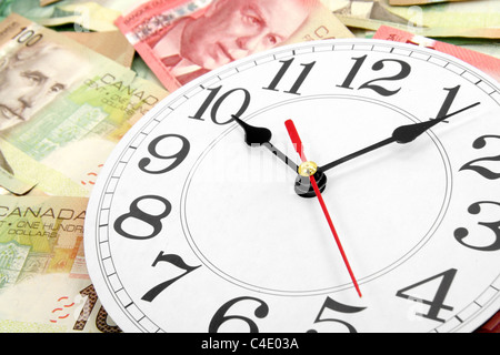 Orologio da parete e dollari canadesi, il concetto di tempo è denaro Foto Stock