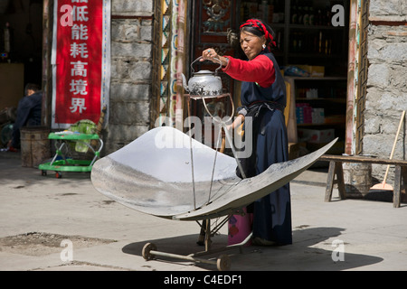 Pentola con reflcetor solare per il tè, Sade, un villaggio tibetano a nord di Julong, Sichuan, in Cina. Foto Stock