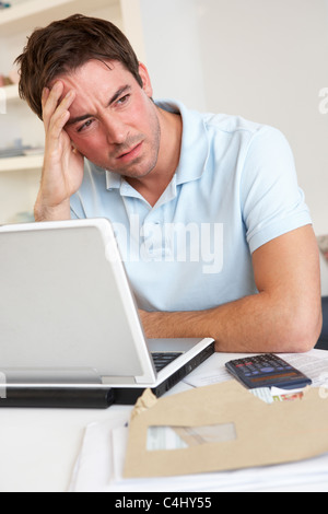 Giovane uomo che lavora con il computer portatile Foto Stock