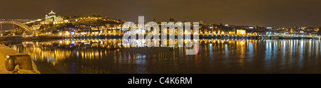 Panorama di vino porto villaggio di storage con canna in cantine di Vila Nova de Gaia riflettendo nel fiume Duora di notte di fronte porto Foto Stock