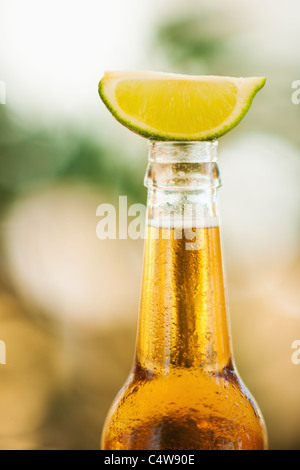 In prossimità di una bottiglia di birra con fetta di lime sulla parte superiore Foto Stock