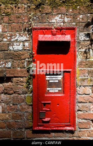 Un Victoria Regina postbox in un muro di mattoni. Bury St Edmunds, Suffolk, Regno Unito Foto Stock