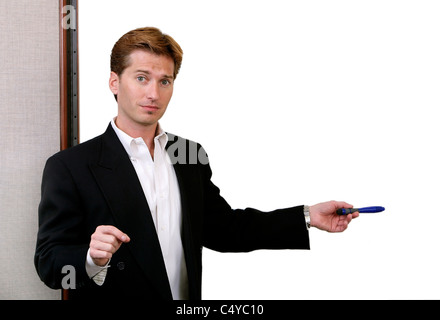 Un infelice 20s imprenditore puntando ad una lavagna vuota Foto Stock