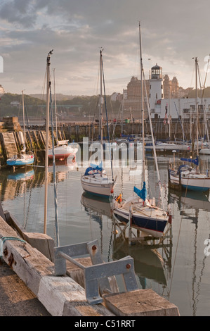 Attracco per imbarcazioni da diporto esterno di Scarborough (yacht e barche ormeggiate dal faro del molo al sole di sera) - scenografica costa dello Yorkshire del Nord, Inghilterra, Regno Unito Foto Stock