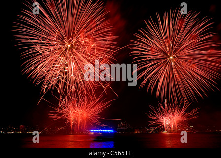 Red fuochi d'artificio esplodere durante l annuale Macy's show sul fiume Hudson a New York City il 4 luglio 2011. © Craig M. Eisenberg Foto Stock