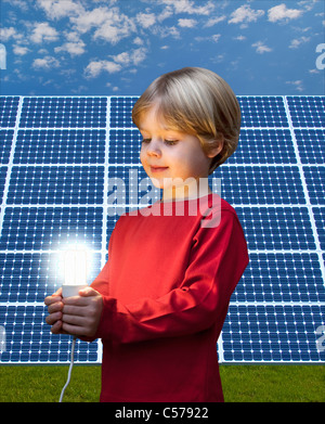 Ragazzo con lampadina da pannello solare Foto Stock