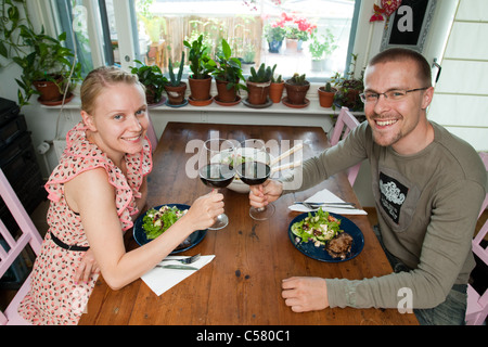 Una coppia felice gode di una cena romantica con un bicchiere di vino Foto Stock