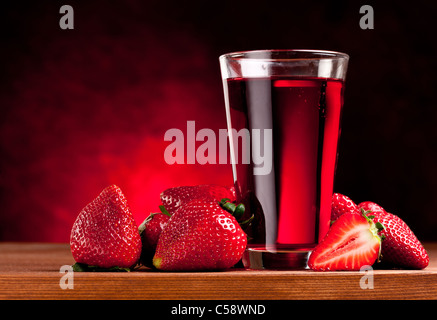 Vetro con succo di fragola e frutti di bosco. Isolato su uno sfondo bianco. Foto Stock