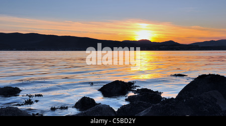 Il sole tramonta su Dunoon, catturato da tutto il Firth of Clyde a Gourock. Foto Stock