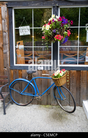 Una vecchia bicicletta blu davanti alla vetrina di un negozio in Cowichan Bay, l'isola di Vancouver, Canada Foto Stock