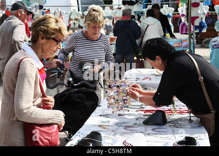 Le donne anziane l'acquisto di gioielli al mercato in stallo Etretat, Normandia, Francia Foto Stock