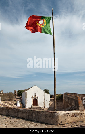 Bandiera portoghese issata nelle mura del castello di Castro Marim, Algarve, PORTOGALLO Foto Stock