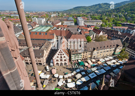 Germania, Baden-Württemberg, Foresta Nera, Freiburg im Breisgau, vista del mercato agricolo a Munsterplatz posto con il paesaggio urbano Foto Stock