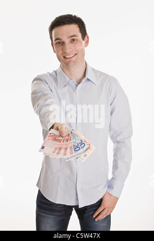 Imprenditore tenendo le banconote in euro, sorridente, ritratto Foto Stock