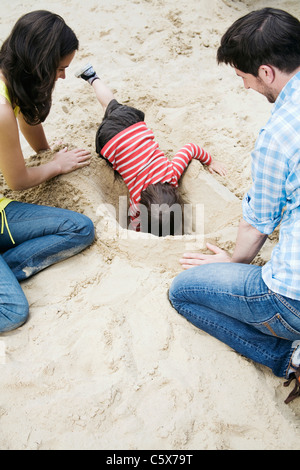 Germania Berlino, Famiglia e figlio (3-4) giocando in sandbox Foto Stock