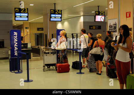 Dall'Aeroporto di Ibiza passeggeri in attesa per la Ryanair banchi check-in per aprire Foto Stock