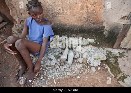 Un bambino si siede sulle strade di banconi, una delle baraccopoli di Bamako, in Mali, Africa occidentale. Foto Stock